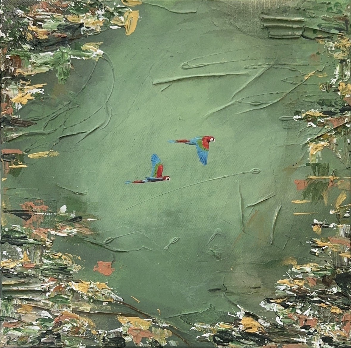A square canvas in soft green with raised, scratched texture, thick strokes of green, ochre, coral and white along the edges, and two tiny red, blue and green parrots in flight at the centre.
